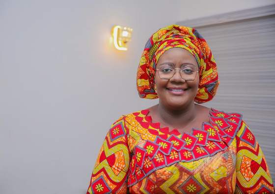 Tombra Mohammed smiling in a bright patterned outfit